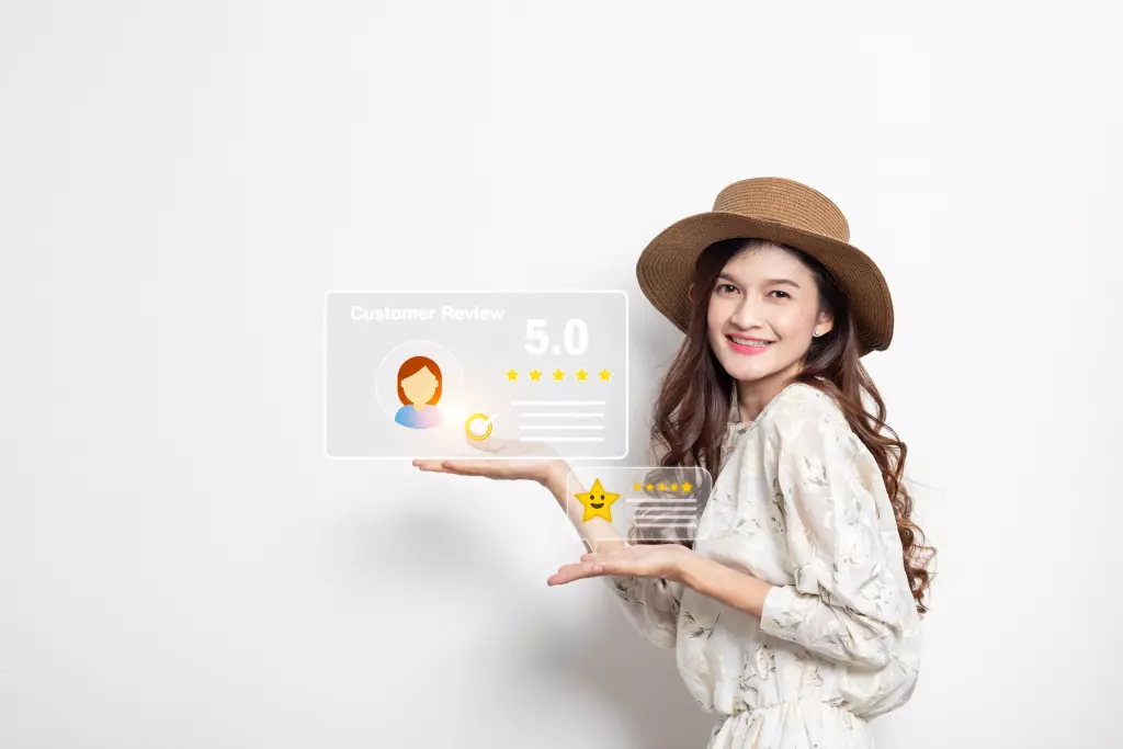 Smiling woman holding her hands under illustrated floating customer review graphics, displaying a 5.0-star rating and positive feedback icon.